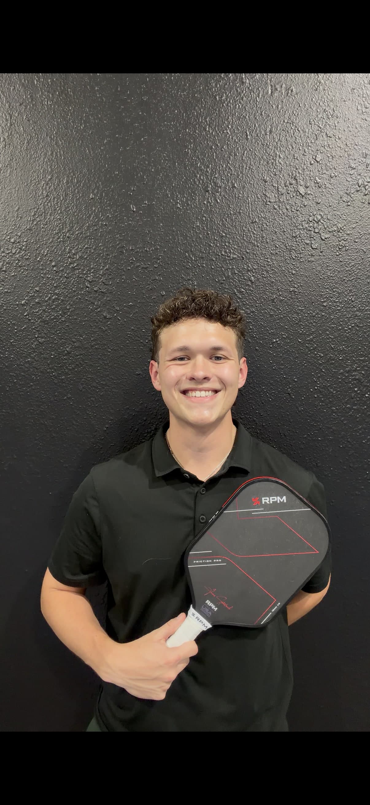 Coach Ryan McCarthy holding his RPM paddle